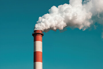 Modern smokestack with red, white bands releases thick white smoke against clear blue sky. This industrial chimney symbolizes energy production, environmental technology, manufacturing processes.