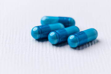 Amino acids capsules on bright background. Soft focus. Close up. Copy space.