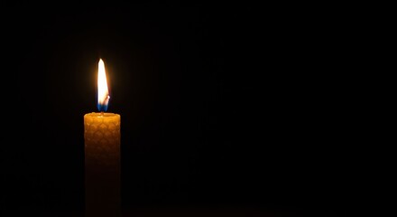 Burning Honeycomb Candle in Darkness