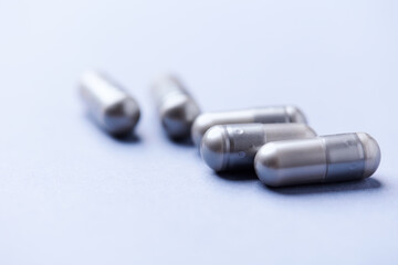 Naklejka premium BCAA amino acids tablets. Nutrition for bodybuilding. Fitness supplements on bright background. Soft focus. Copy space.