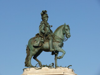 Equestrian statue of a historic figure under clear blue sky. Monumental bronze sculpture captured...
