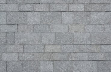 Obraz premium Close-up of grey concrete paving slabs with geometric stone pattern. Textured cement blocks form seamless surface for outdoor terraces, walkways, streets. Natural stone material provides durable,