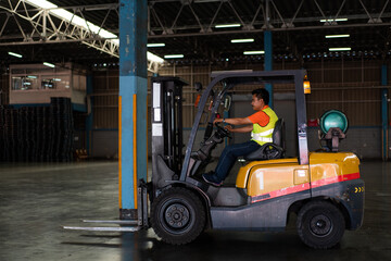 Factory worker driving a forklift in a warehouse. Represents logistics, material handling, and industrial transportation, loading cargo, shipping delivery