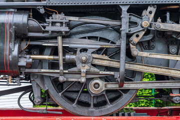 Coupling rod details with the large drive wheel of a locomotive on the Isle of Wight Steam Railway line