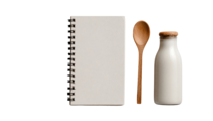 A blank spiral-bound notebook, a wooden spoon, and a milk bottle arranged on a plain background