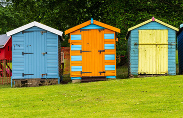 Three painted colourful beach huts by Appley Beach in Ryde on the Isle of Wight