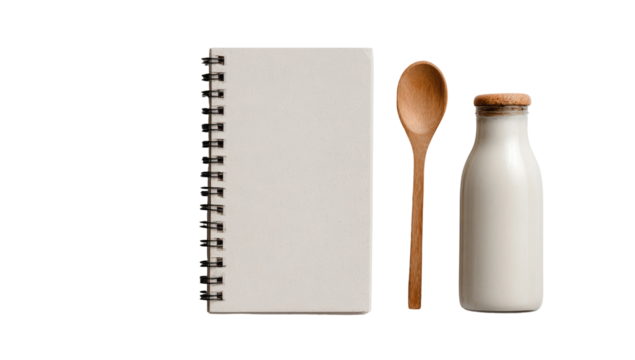 A blank spiral-bound notebook, a wooden spoon, and a milk bottle arranged on a plain background
