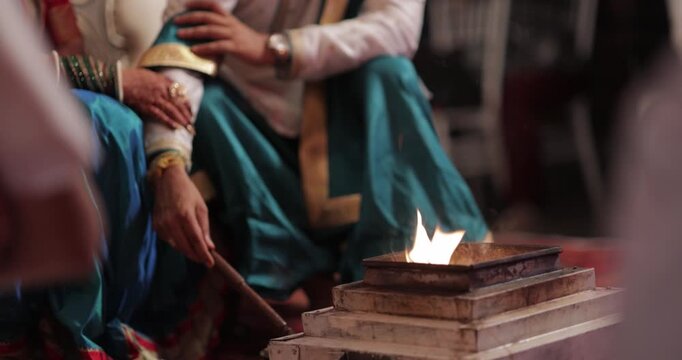 Bride and Groom Offering Samidha During Sacred Fire
