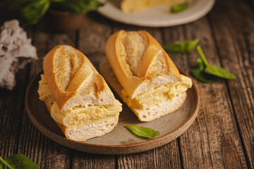 Spanish potato omelette sandwich. Typical Spanish food, Bocadillo de tortilla espanola very popular snack in Spain on white rustic background