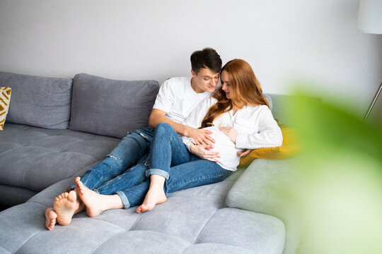 Young couple embracing parenthood with love