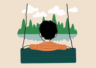 Boy on a swing facing a serene lakeside view
