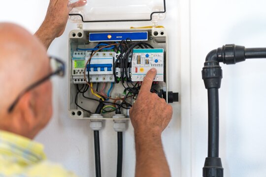 Senior electrician operating circuit breaker panel