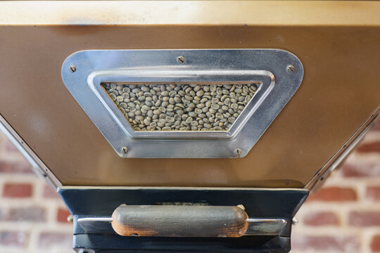 Modern coffee roaster with raw beans shown inside hopper