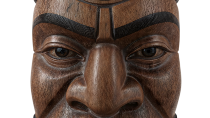 Closeup of detailed wooden mask with expressive eyes and engraved eyebrows on the transparent background