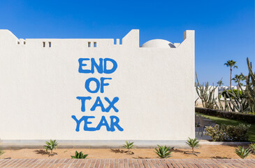End of tax year symbol. Concept words phrase End of tax year on beautiful white wall. Beautiful...