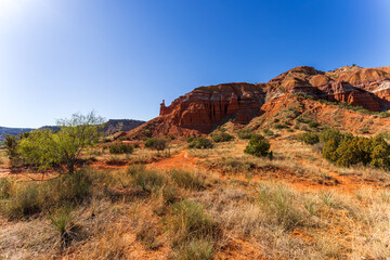 Stunning View of Palo Duro Canyon in Texas with Red Rock Formations Under a Clear Blue Sky