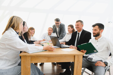 Business team collaborating on project during productive office meeting