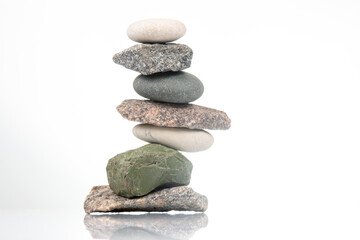 Stacked stones exhibiting balance and harmony in minimalist composition on white background
