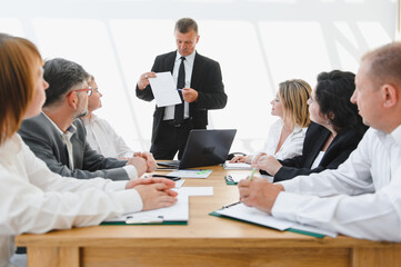 Business team meeting, leader explaining strategy to colleagues