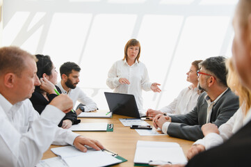 Business team meeting, female leader inspiring her colleagues