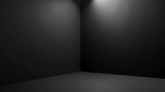 A dark room corner with light shining from above illuminating the walls and floor surface