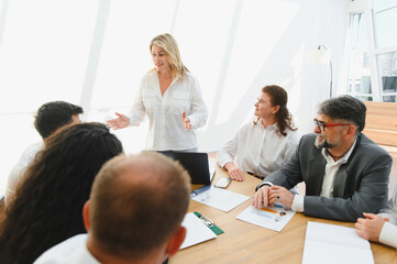 Business team meeting, female leader inspiring her colleagues