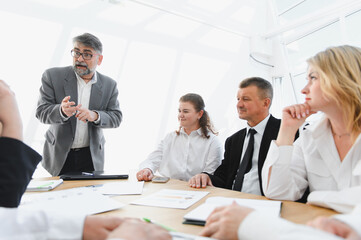 Senior business leader addressing team during important meeting