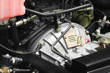 Shown is a large engine with many tubes, bolts and various parts. Auto service concept background