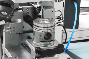 Checking testing measuring engine piston on the stand before service repair, auto service concept