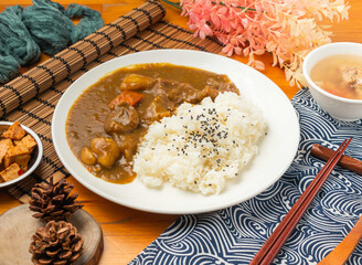 Curry Beef Rice Set with Savory Gravy and Side Dishes in plate side view of Asian food