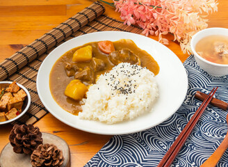 Japanese Curry Pork Rice Set with Savory Sauce and Side Dishes in plate side view of Asian food