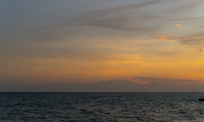 Colorful sunset and dusk skies with soft cloud formations over the sea horizon. Peaceful twilight landscapes ideal for background, nature themes, or tranquil mood concepts.