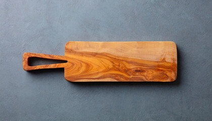 Brown Wooden cutting board. Gray background. Close up. Copy space. Top view.
