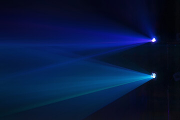 Blue and purple beams in dark background.