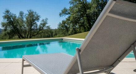 Serene Poolside Relaxation: Close-Up of a Modern Lounger with Turquoise Water Backdrop