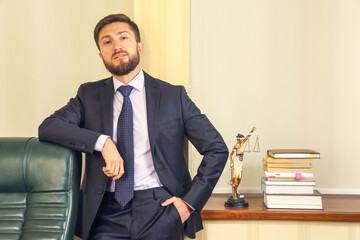 Professional lawyer in a suit poses confidently in an office with law books