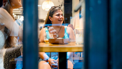 Woman enjoying dinner at cozy restaurant interior