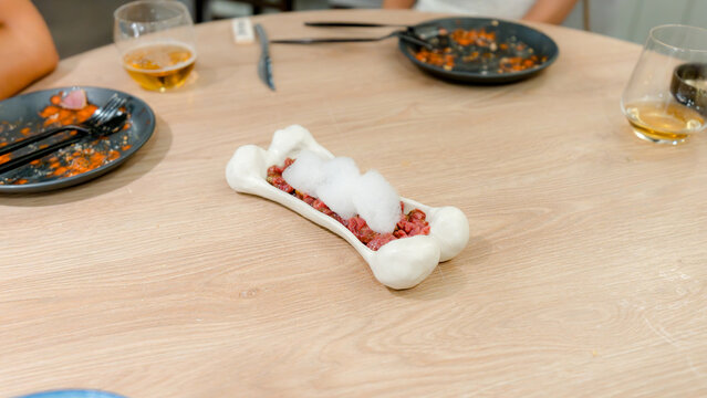 Gourmet dish served in unique bone-shaped platter