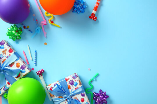 Bright birthday party decorations on blue background. Happy Birthday greeting card template. Flat lay, top view.