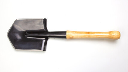 Garden shovel with wooden handle ready for outdoor use in backyard landscaping