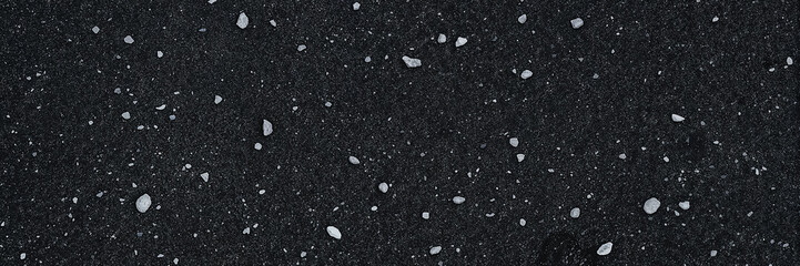 Dark Textured Surface with Scattered White Pebbles abstract background
