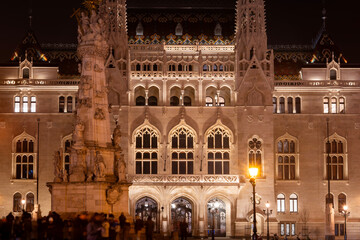 Fototapeta premium The illuminated Gothic facade of the Hungarian Ministry of the Interior building at night in Budapest