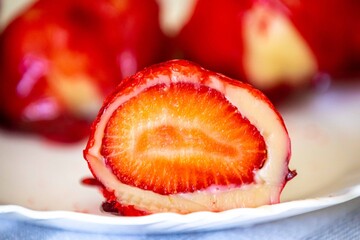 The iconic and delicious Brazilian strawberry of love, prepared with fresh strawberries, white brigadeiro and crunchy caramel on the surface. Morango do amor