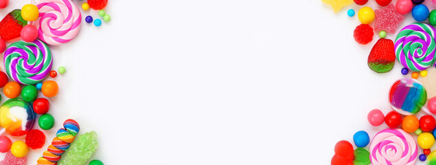 Colorful collection of candies. Top view double border over a white banner background.