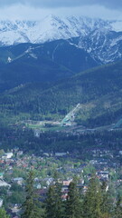 oramic view of Zakopane city with snowy Tatra Mountains and ski jump hill in Poland
