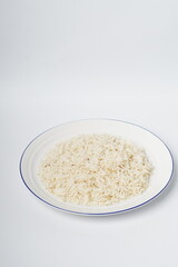 Cooked white rice in a plate, plan white rice in a white plate isolated on the white background shot in a soft studio lights