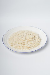 Cooked white rice in a plate, plan white rice in a white plate isolated on the white background shot in a soft studio lights