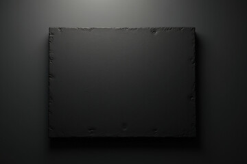 A black clean board on sleek black surface, top view with surreal minimalist look and film grain style, space for copy.