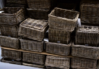  Woven storage baskets stacked neatly on a shelf, showcasing natural textures and rustic charm for home organization