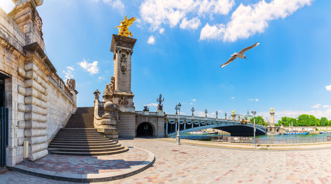 Elegant view of Alexandre III Bridge over Seine river, with sculptures and waterfront steps, Paris, France - Powered by Adobe